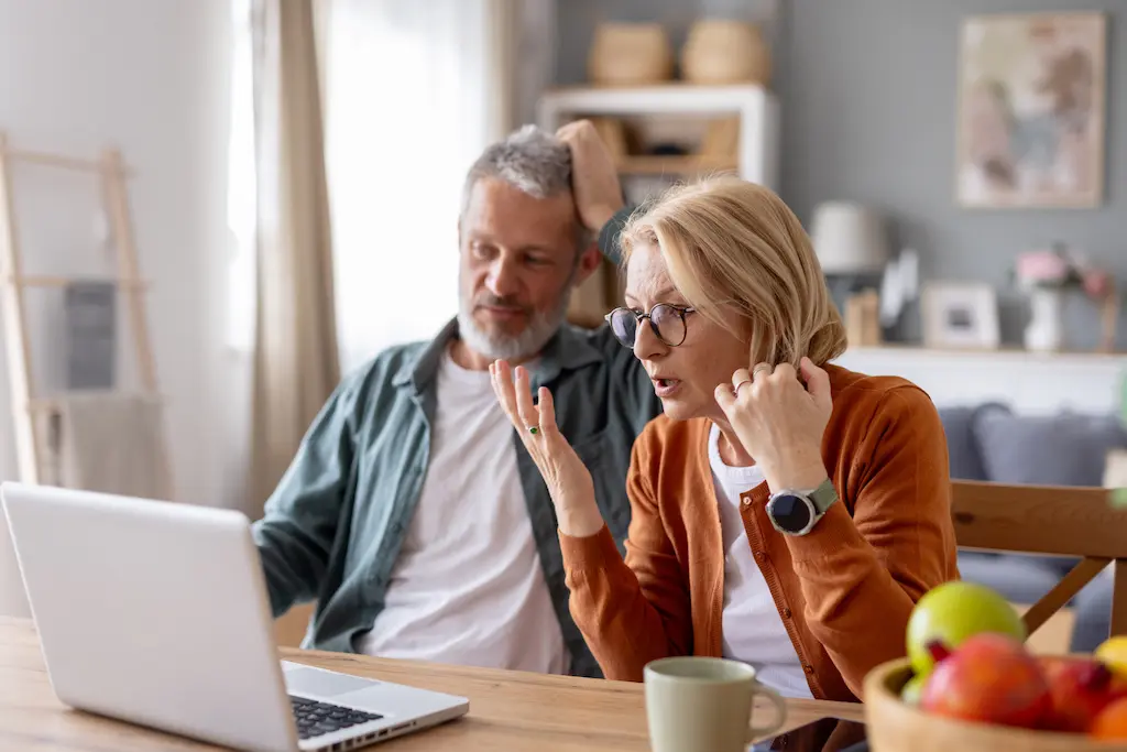 Senior couple/person emotionally distressed over online financial scam